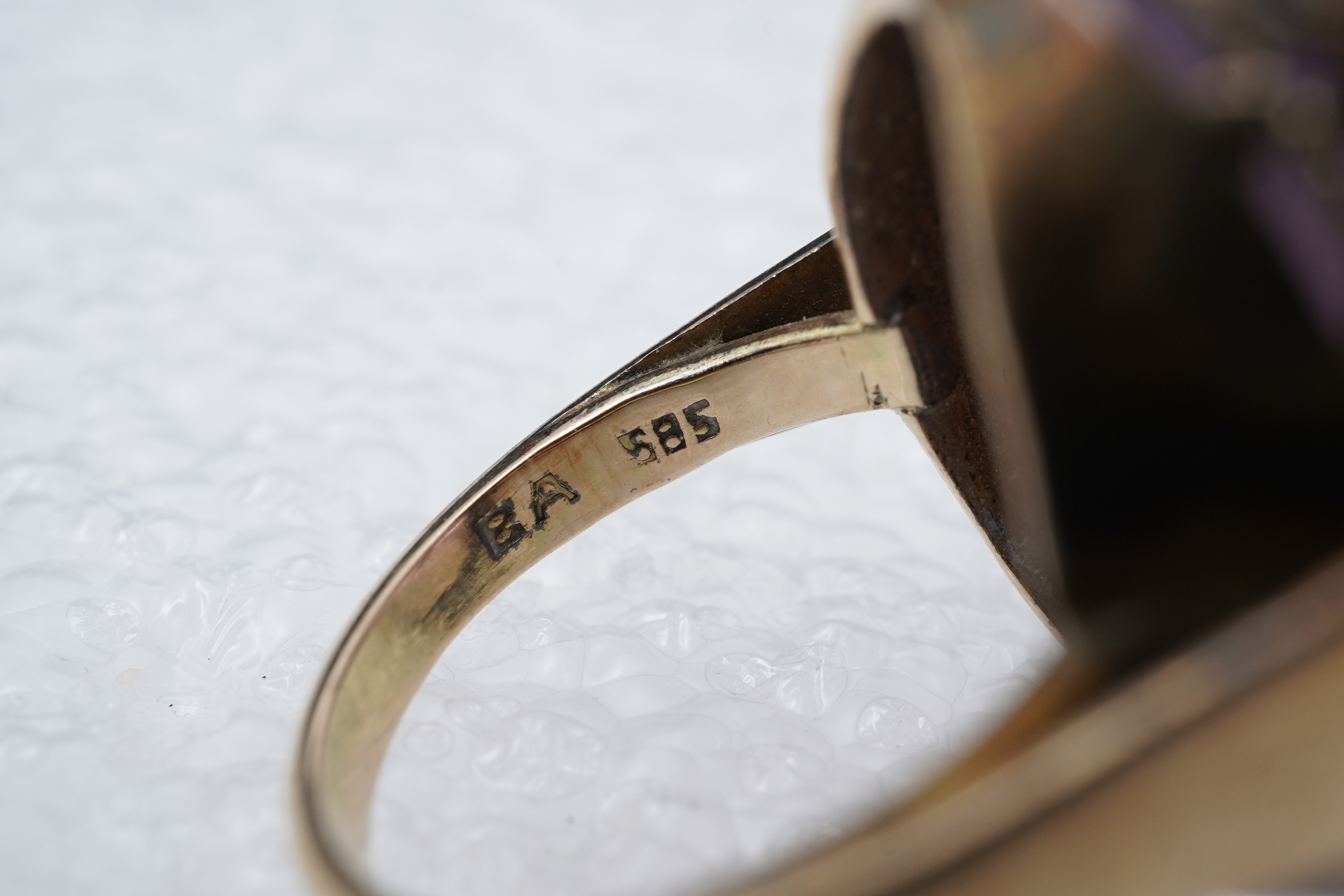 An amethyst ring, necklace and pendant, comprising: an oval amethyst set in a floral gilt silver necklace, length 32cm; an oval amethyst and seed pearl pendant, length 3.7cm; and a ring set with an oval amethyst, mounted